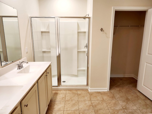 5088 Wavering Place Loop, Myrtle Beach, SC 29579 - full bathroom with a stall shower, a spacious closet, double vanity, baseboards, and tile patterned flooring