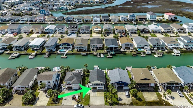 drone / aerial view featuring a residential view and a water view