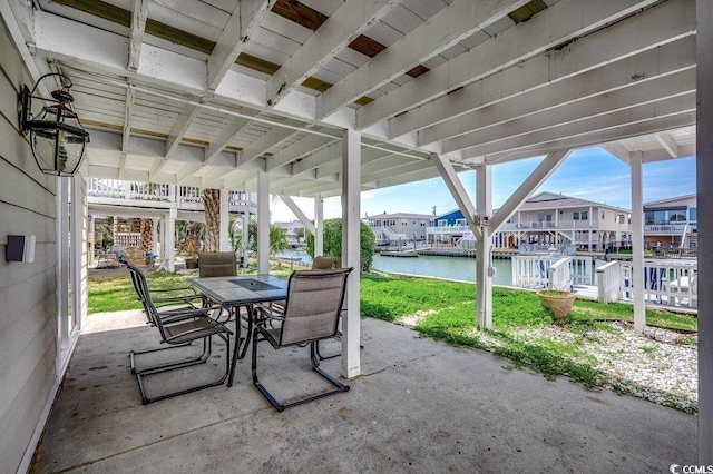 view of patio / terrace with a water view and outdoor dining space