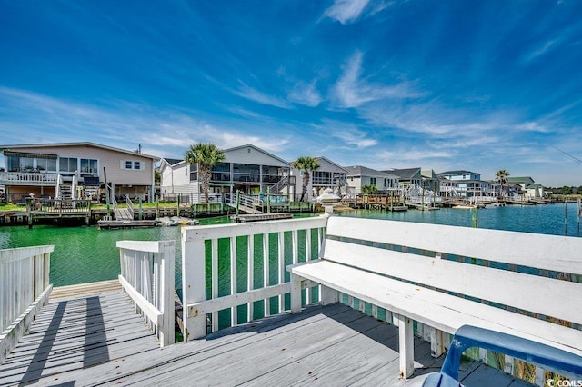 dock area with a residential view and a deck with water view