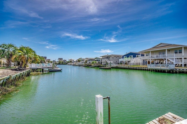 dock area with a residential view and a water view