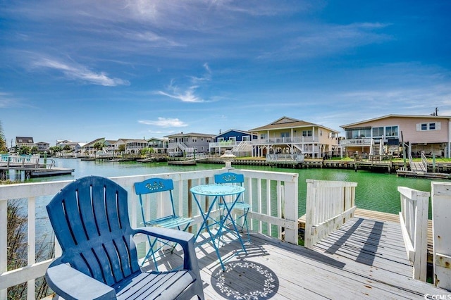 view of dock featuring a residential view and a water view