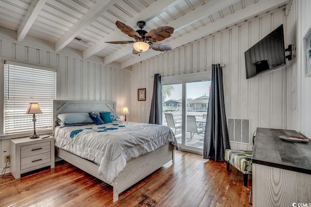 bedroom with vaulted ceiling with beams, wood-type flooring, access to exterior, and visible vents