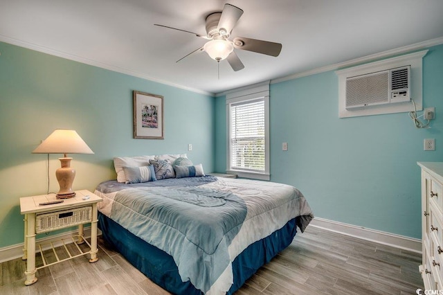bedroom featuring baseboards, ornamental molding, wood finished floors, and a wall mounted air conditioner