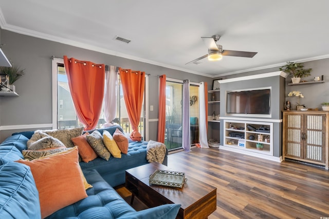 living room featuring visible vents, crown molding, ceiling fan, and wood finished floors