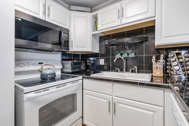 kitchen featuring a sink, tasteful backsplash, white cabinetry, and white electric stove