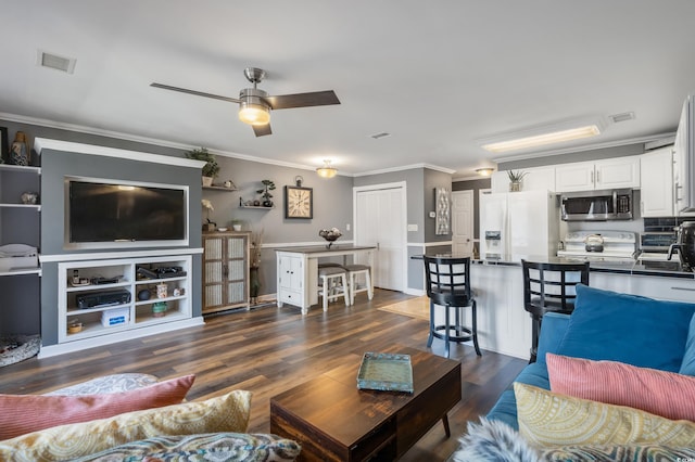 living area featuring ceiling fan, visible vents, dark wood-style flooring, and ornamental molding
