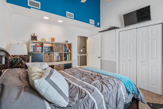 carpeted bedroom with visible vents and crown molding
