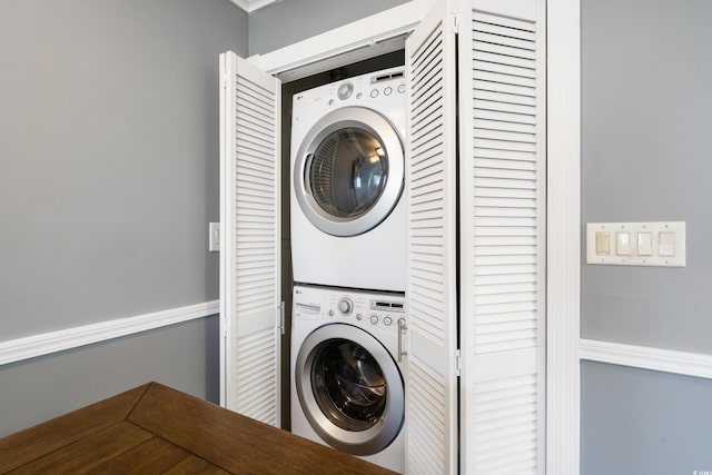 laundry room with stacked washer and dryer and laundry area