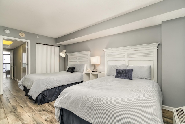 bedroom with wood finished floors and baseboards