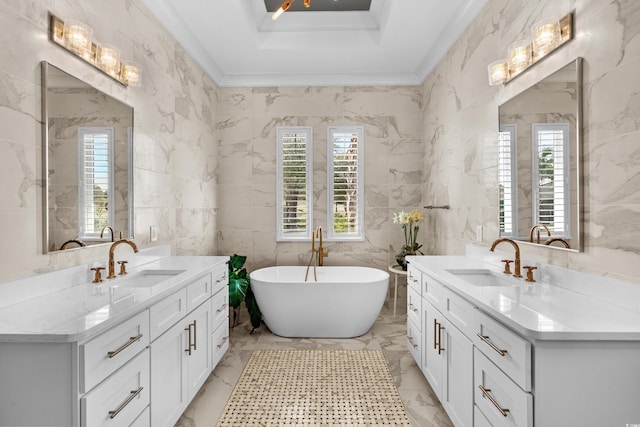 bathroom featuring a healthy amount of sunlight, marble finish floor, and a sink