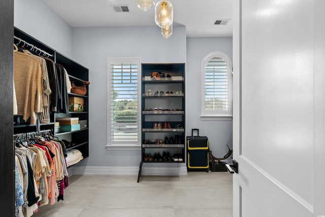walk in closet featuring tile patterned flooring and visible vents