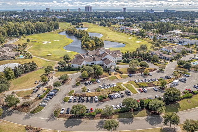 bird's eye view featuring a water view, a view of city, and view of golf course