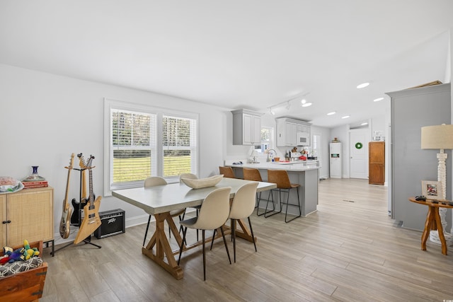 dining area with recessed lighting, light wood-type flooring, and baseboards