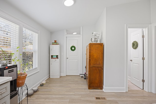 interior space with visible vents, light wood-type flooring, and baseboards