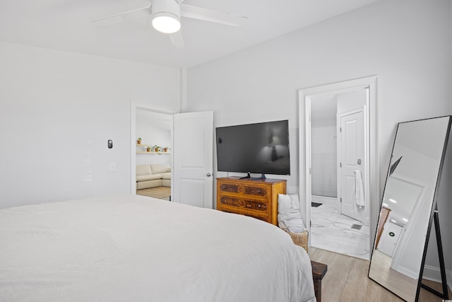 bedroom featuring ensuite bath, ceiling fan, and light wood finished floors