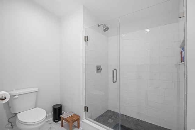 full bath featuring baseboards, toilet, marble finish floor, and a stall shower