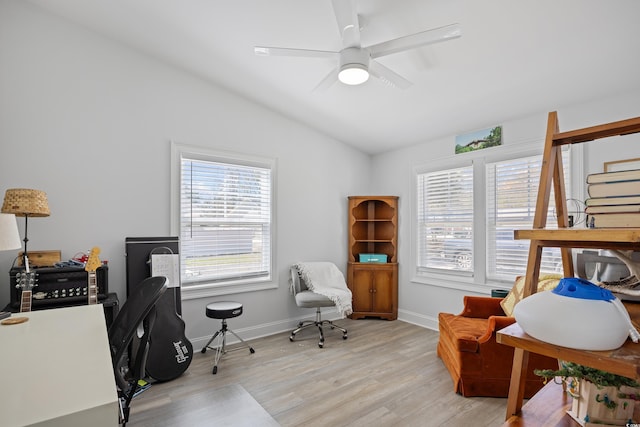 office featuring baseboards, lofted ceiling, ceiling fan, and light wood finished floors