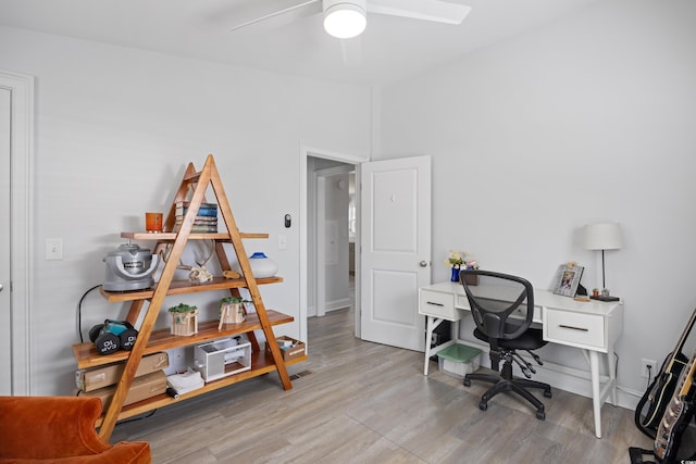 home office with baseboards, ceiling fan, and wood finished floors