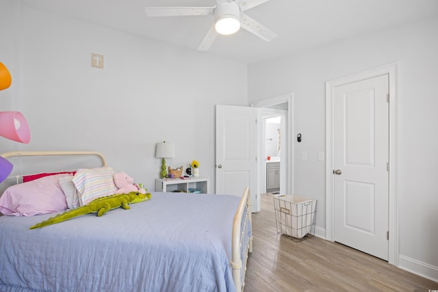bedroom featuring baseboards, wood finished floors, and a ceiling fan