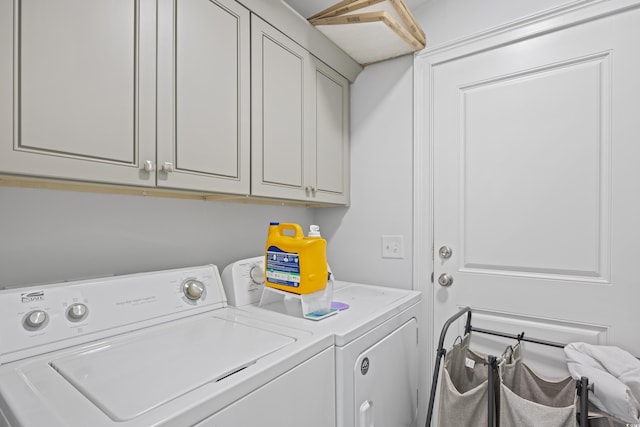 laundry area with washer and clothes dryer and cabinet space