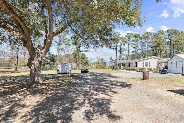 view of street with dirt driveway