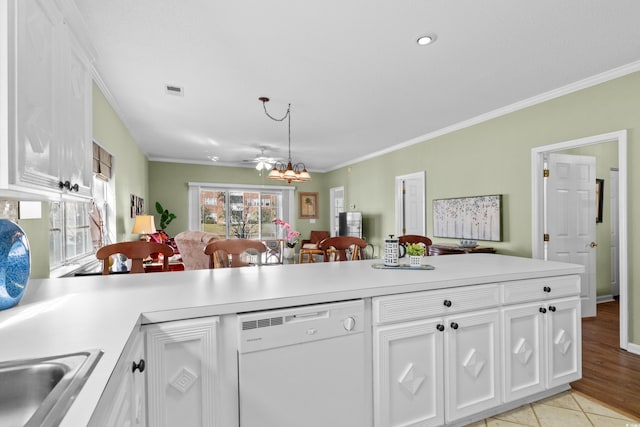 3927 Gladiola Ct Unit 101, Myrtle Beach, SC 29588 - kitchen with white dishwasher, a peninsula, ornamental molding, white cabinetry, and light countertops