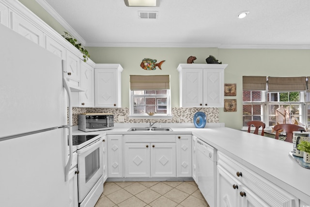 3927 Gladiola Ct Unit 101, Myrtle Beach, SC 29588 - kitchen featuring white appliances, a sink, healthy amount of natural light, ornamental molding, and light countertops