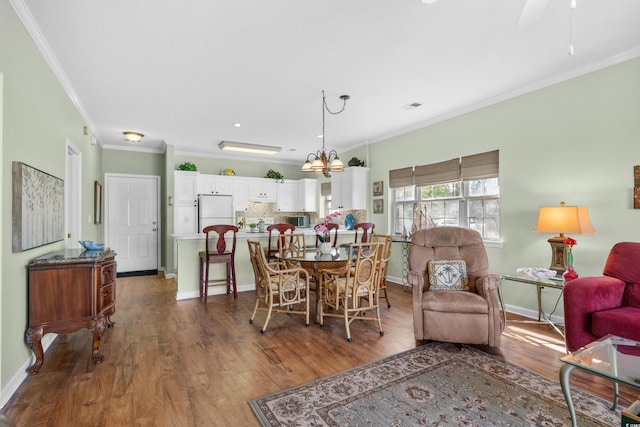 3927 Gladiola Ct Unit 101, Myrtle Beach, SC 29588 - dining room with ornamental molding, wood finished floors, baseboards, and ceiling fan