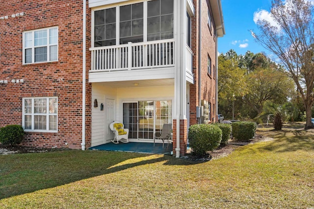 3927 Gladiola Ct Unit 101, Myrtle Beach, SC 29588 - rear view of property featuring brick siding, a lawn, a patio area, and a balcony