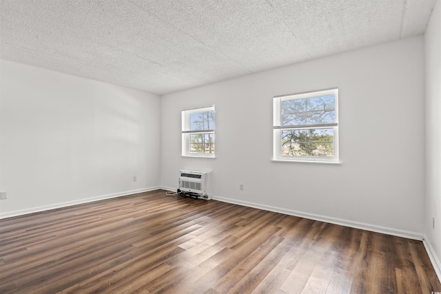 6850 Blue Heron Blvd Unit 205, Myrtle Beach, SC 29588 - empty room with an AC wall unit, baseboards, and dark wood-style flooring