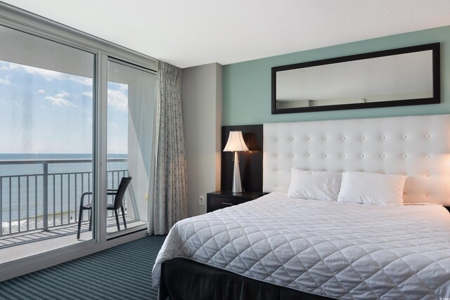107 S Ocean Blvd Unit 704, Myrtle Beach, SC 29577 - bedroom featuring a water view, access to outside, and carpet floors
