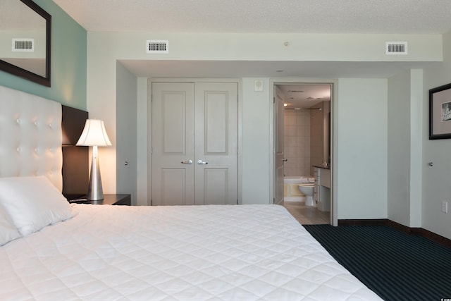 107 S Ocean Blvd Unit 704, Myrtle Beach, SC 29577 - tiled bedroom featuring a closet, ensuite bath, and visible vents