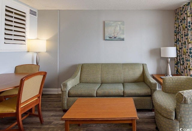 living area with visible vents and wood finished floors