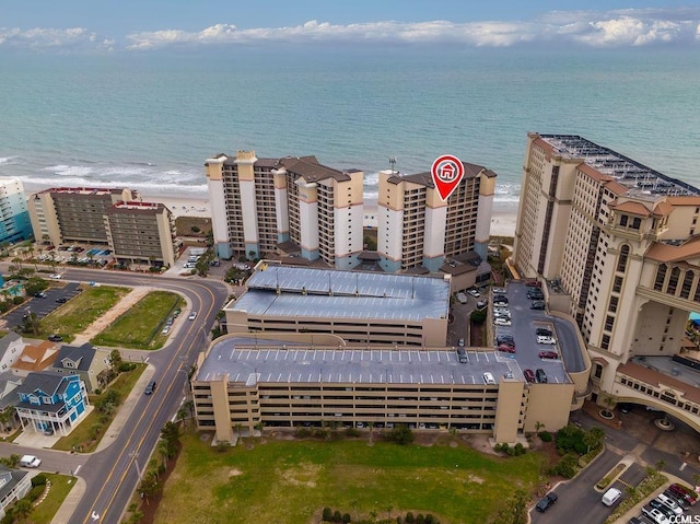 aerial view with a water view and a beach view
