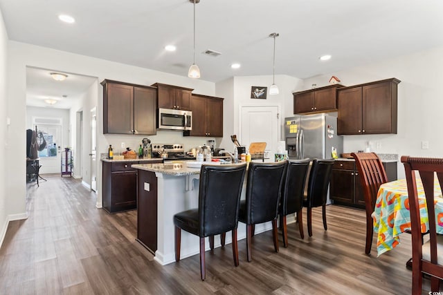 2848 Ophelia Way, Myrtle Beach, SC 29577 - kitchen with appliances with stainless steel finishes, dark brown cabinets, dark wood-style floors, a breakfast bar, and recessed lighting