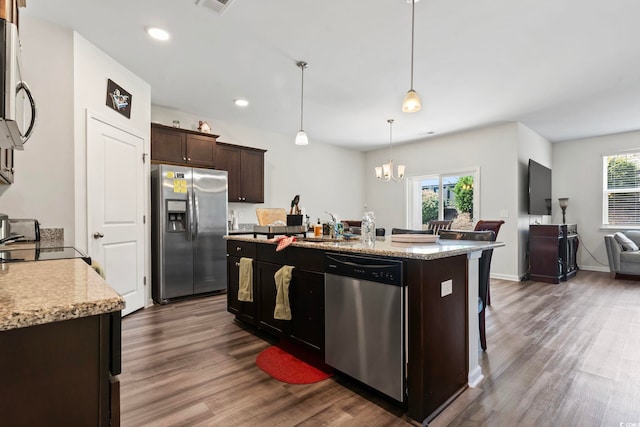 2848 Ophelia Way, Myrtle Beach, SC 29577 - kitchen featuring appliances with stainless steel finishes, dark wood-type flooring, a center island with sink, dark brown cabinets, and open floor plan