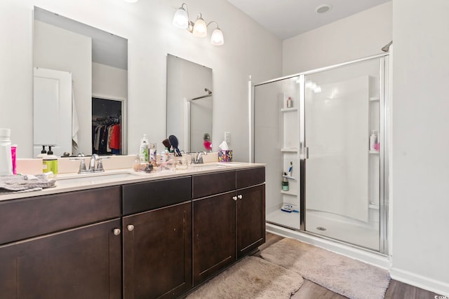 2848 Ophelia Way, Myrtle Beach, SC 29577 - bathroom featuring wood finished floors, a shower stall, double vanity, and a walk in closet