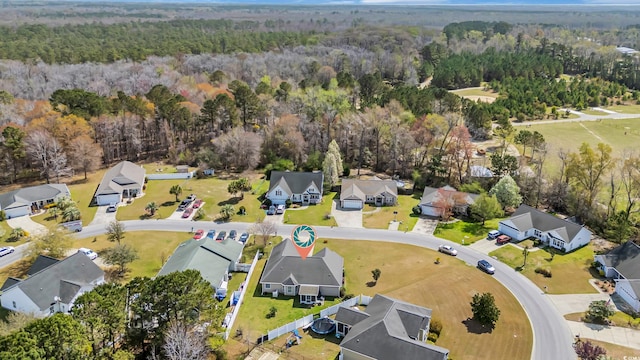 aerial view featuring a view of trees and a residential view