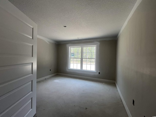 2929 Hughes Gasque Rd, Aynor, SC 29511 - spare room featuring baseboards, concrete flooring, a textured ceiling, and ornamental molding