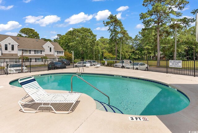 500 Fairway Village Dr Unit 7-D, Myrtle Beach, SC 29588 - community pool with view of scattered trees and a patio