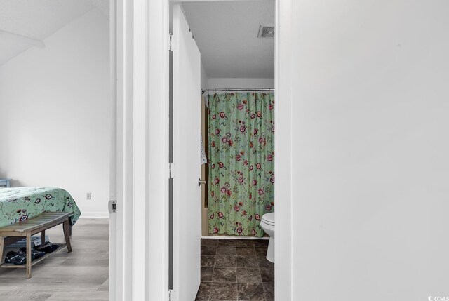500 Fairway Village Dr Unit 7-D, Myrtle Beach, SC 29588 - bathroom featuring toilet, baseboards, and curtained shower