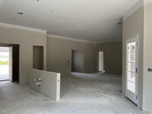 spare room with a textured ceiling