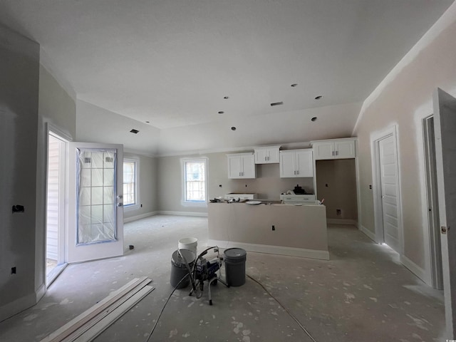 2921 Hughes Gasque Rd, Aynor, SC 29511 - kitchen featuring lofted ceiling, white cabinetry, a center island, and baseboards