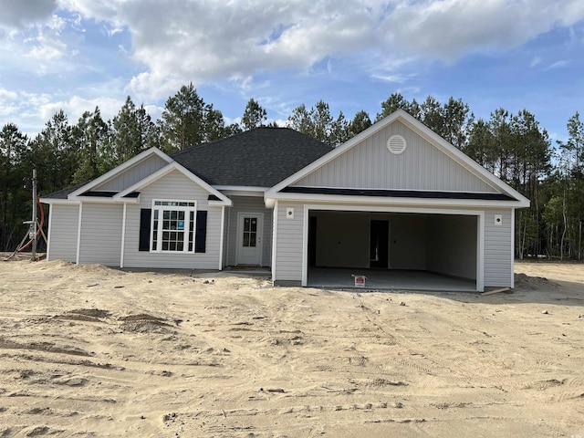 view of front of property with roof with shingles and a garage