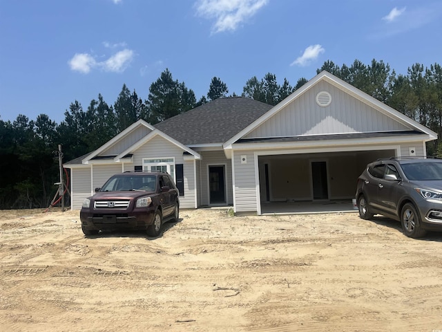 2921 Hughes Gasque Rd, Aynor, SC 29511 - view of front of property featuring a garage, a shingled roof, and driveway