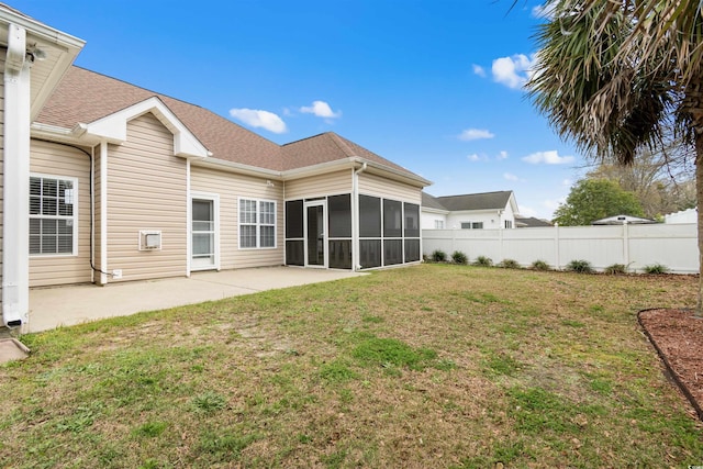 back of house featuring fence, a yard, roof with shingles, a sunroom, and a patio area