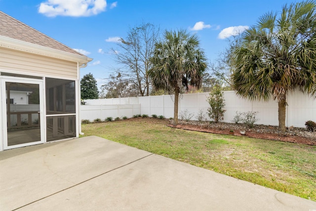 view of yard with a sunroom, fence, and a patio area