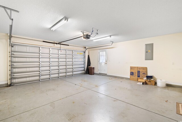 garage with electric panel, baseboards, and a garage door opener