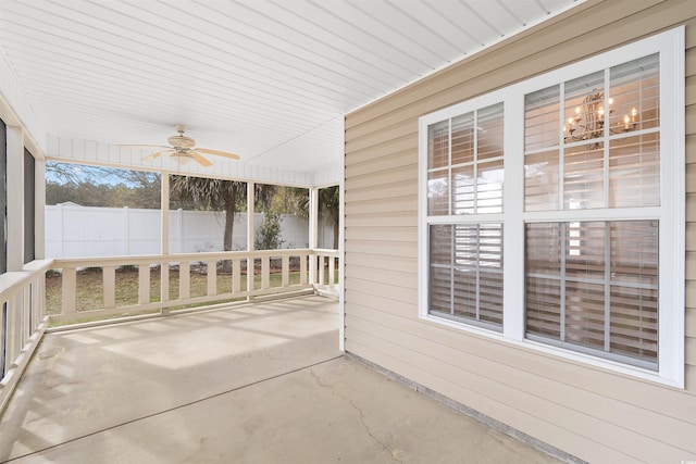 unfurnished sunroom featuring a ceiling fan
